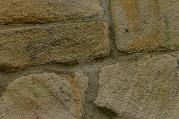 This closeup image showcases a beautifully crafted stone wall with unique shapes and intricate mortar joints, highlighting exceptional skill and artistry in masonry by skilled artisans
