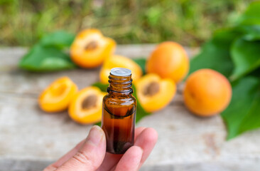Apricot essential oil in a bottle. Selective focus.