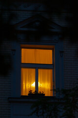 A window glows warmly amidst the dark exterior, hinting at the inviting activities inside. This scene sparks mystery and intrigue, inviting viewers to imagine the stories within