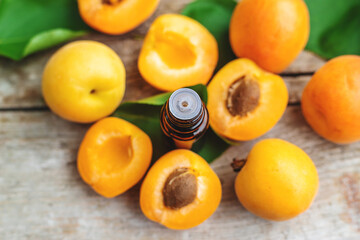 Apricot essential oil in a bottle. Selective focus.