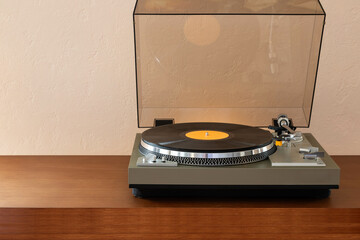 Vintage Stereo Turntable Record Player With Black Disk and Weight Clamp