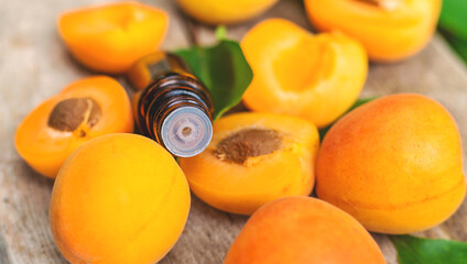 Apricot essential oil in a bottle. Selective focus.