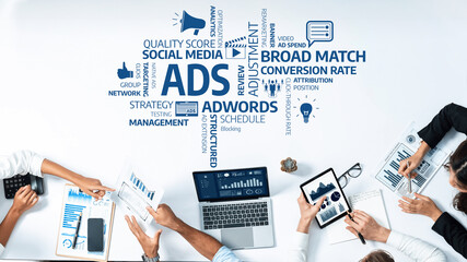 A professional workspace showing collaboration on marketing strategies with charts, reports, and digital devices, enhancing advertising and social media performance metrics. Amity