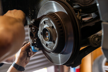 brake disc with replaced brake pads in the car done by service