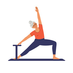 Elderly woman doing pilates in a yoga pose on a mat  