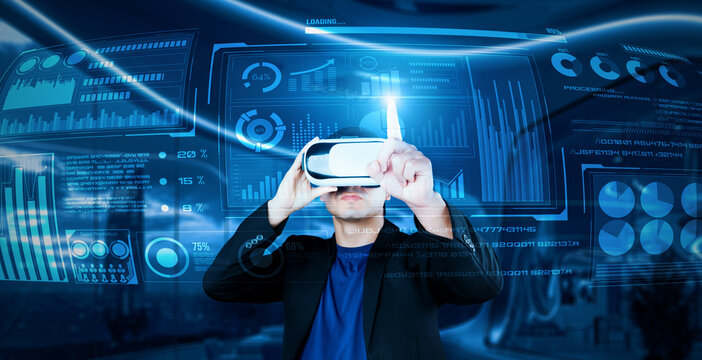 Project manager with VR goggles pointing financial chart and glowing blue light at office. Skilled businessman checking and planning marketing strategy by using data from augmented reality. Ingenuity. - Powered by Adobe
