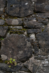 The stone wall of the old fortress of Gvara. The background is a stone wall