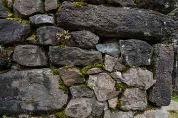 The stone wall of the old fortress of Gvara. The background is a stone wall