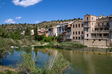Fototapeta premium Picturesque Spanish village Valderrobres with old stone bridge and iconic castle and church skyline, in Teruel region.