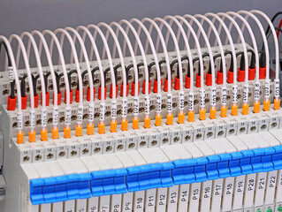 Connection of electromagnetic relays using copper electrical wires in colored insulation. 