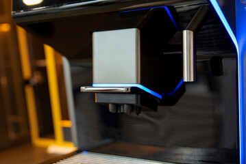 Close-up of coffee dispenser and drip tray