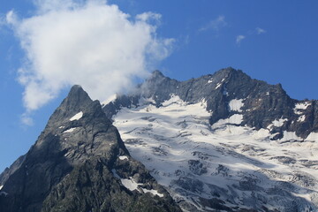 mountain peaks in the clouds North Caucasus Dombay Elbrus region midsummer