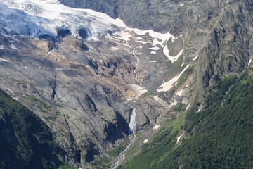 Mountain streams from melting glaciers in the Caucasus Mountains in Dombai in midsummer