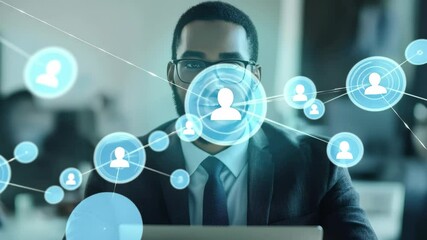 Connecting ideas through technology while using a laptop in a modern workspace, network of connections with icons over biracial businessman having video call - Powered by Adobe