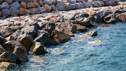 Rocks of the Mediterranean Sea in the port of the French city of Banyuls-sur-Mer, vacation in Europe, summer