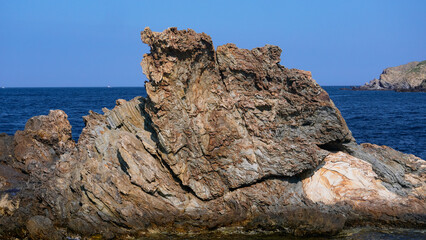 Rocks of the Mediterranean Sea in the port of the French city of Banyuls-sur-Mer, vacation in Europe, summer
