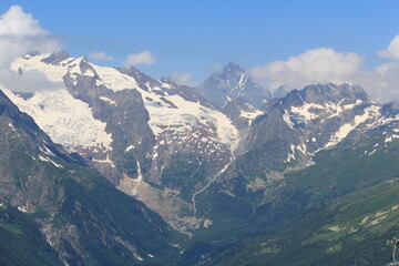 mountain peaks of elbrus region in dombai in midsummer
