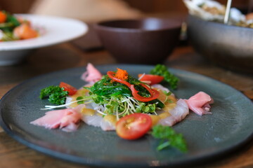 Boiled white rice with salted red fish, cucumbers and other vegetables with herbs in a plate. High quality 4k footage