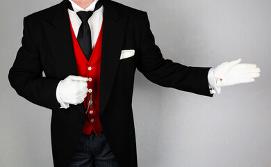 Butler or Hotel Concierge in Formal Attire and White Gloves Making Welcoming Gesture. Service Industry and Professional Hospitality.