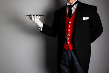 Butler in Formal Attire and White Gloves Holding Serving Tray. Service Industry and Professional Hospitality.