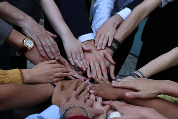 Hands of boys in a circle as a sign of unity and brotherhood