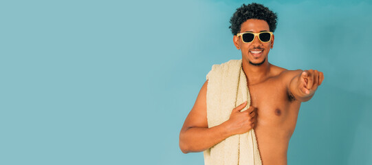young man with sunglasses in swimming trunks in summer isolated on background