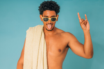 young man with sunglasses in swimming trunks in summer isolated on background
