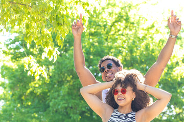 young latin couple smiling happily, laughing