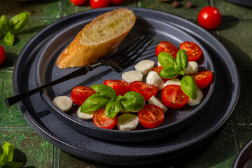 Fresh caprese salad with cherry tomatoes and basil