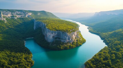 Aerial View of a Serpentine River Winding Through a Lush Green Canyon