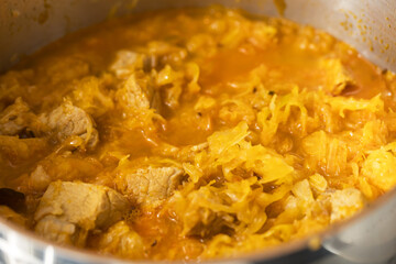 Pork is cooked in a pot with cabbage for Szeged goulash
