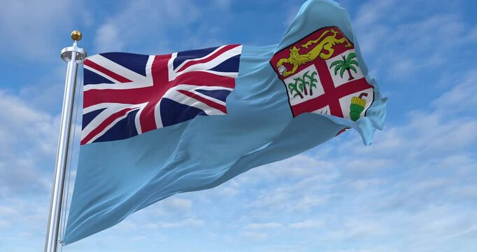 Fiji flag with flagpole waving in wind, rolling clouds background looping, 4K video (Perfect Loop)