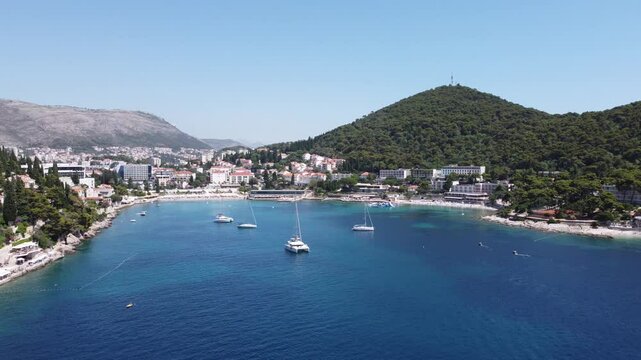 4K Aerial View of Uvala Lapad Beach with Yachts on a Sunny Summer Day