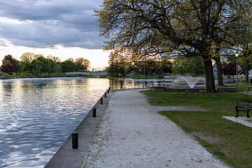 Park along river with fountain in Smiths Falls town in Ontario, Canada in spring season during sunset. Centennial Park