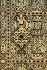 Morocco, Rabat. Detail of a typical old arabesque intricate engraved brass door. Islamic symetrical designs.