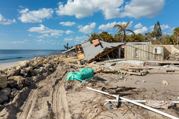 Storm surge severe damage to residential houses on ocean shore after hurricane landfall. Natural...