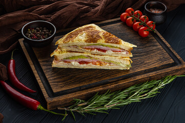 Ham sandwich on a wooden tray