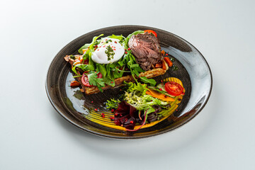 Potato waffle with roast beef on a white table