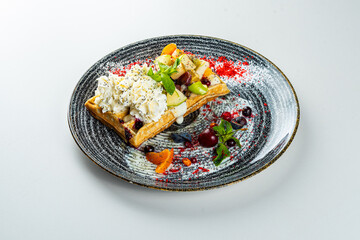 Poppy seed wafer with cream cheese on a white table