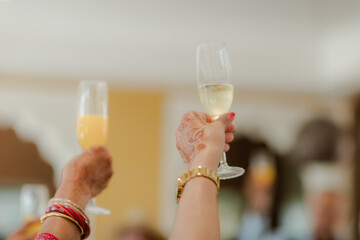 Festive Toast: Hands raised, clinking glasses. Celebratory cheers, marked with traditions, and a shared moment of joy and togetherness. #CelebrationMoment