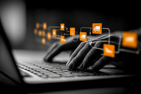 Hands typing on a laptop keyboard with digital logistics and transportation icons overlay