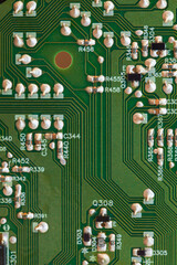 Detailed close-up of an electronic circuit board, vertical photo