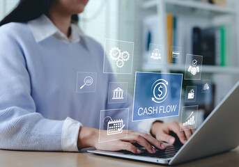 Cash flow management and financial analysis concept. Businessperson working on laptop with financial icon representing cash flow, banking, investment, business management, strategy, and data analysis.