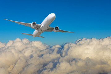 Travel with airplane flying in the blue sky over the clouds. Flying plane against the backdrop of...