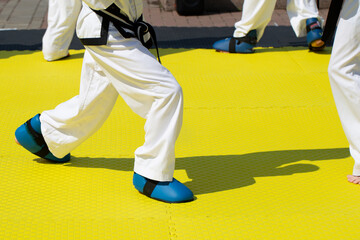People practice taekwondo on the street. Outdoor exercise.