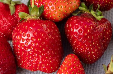 Close-up of ripe juicy strawberries with natural defects