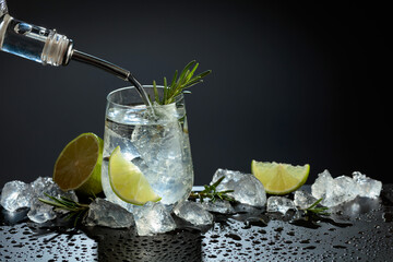 Gin and tonic cocktail made with dry gin, tonic water, lime, and ice.