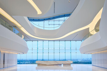 A bright and airy lobby showcases modern architecture with curving lines, large windows, and a stunning view of the skyline under a clear sky. Generative AI.