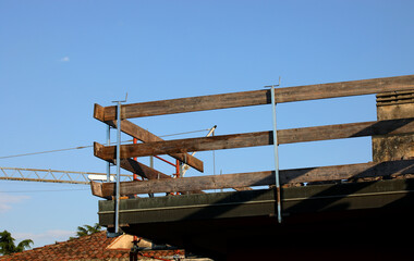 barrier with wooden planks firmly installed on the roof for the protection of workers to avoid...