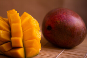 Close-Up of Fresh Mango Slices and a Whole Mango on Wooden Surface
